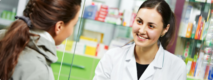 Woman Pharmacist talking with the customer